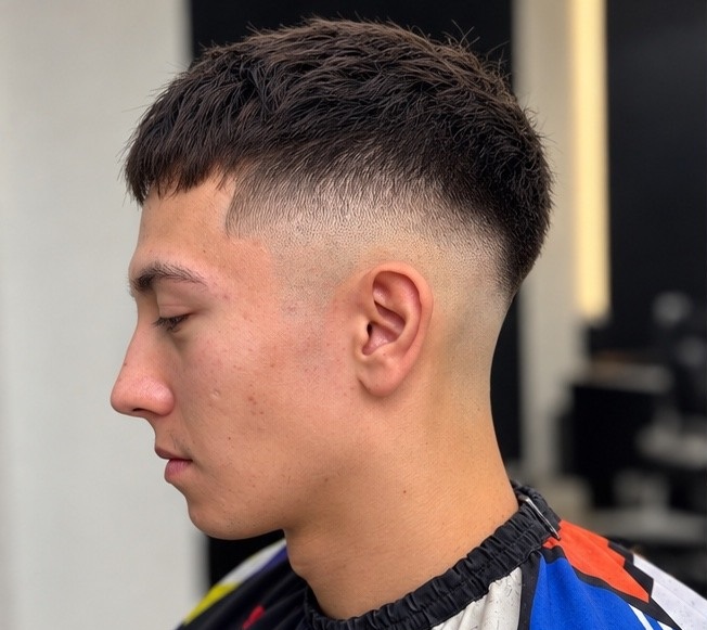Client haircut, side profile with textured top and fade