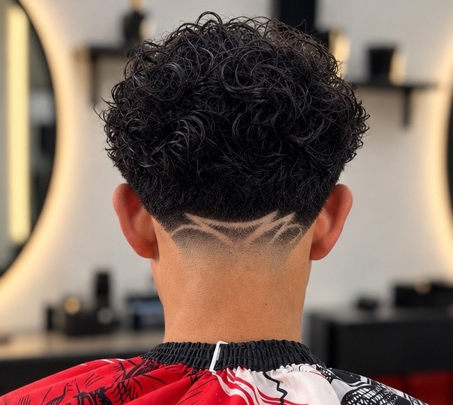Curly haircut with a detailed nape design