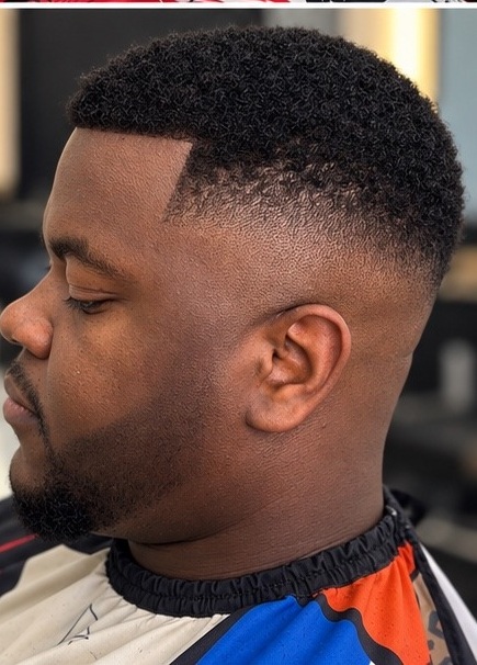 Short curly hair with a sharp fade