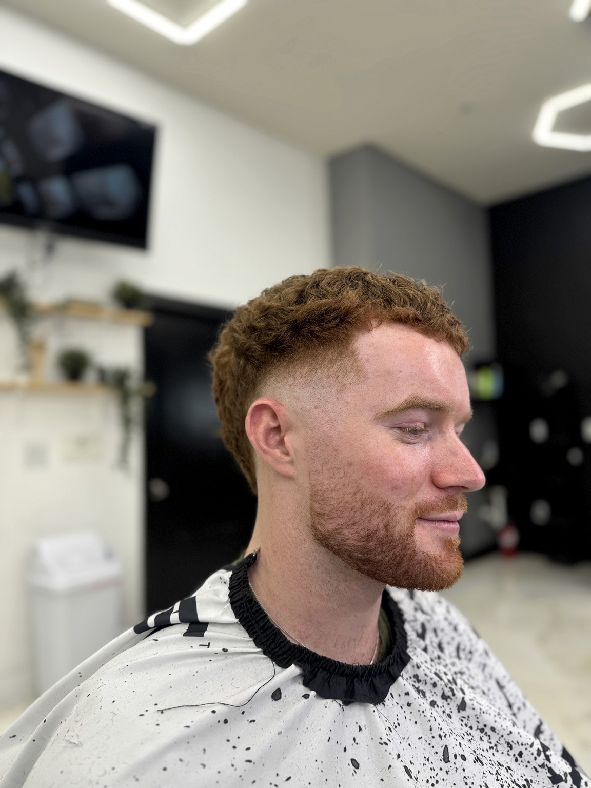 Client with curly ginger hair and beard after a haircut